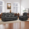 Two black leather sofas in a spacious living room with wooden floor, large windows, and decorative items.